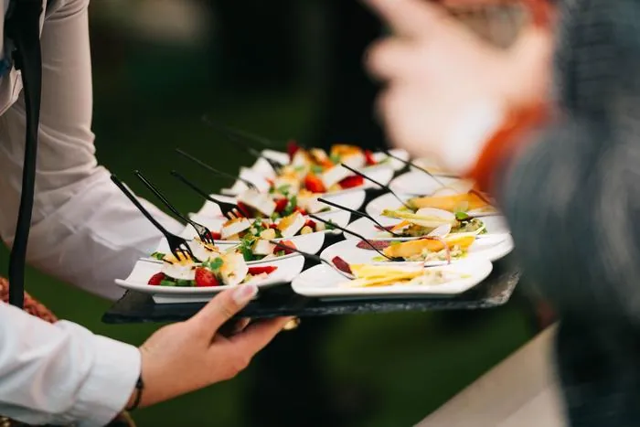 Catering staff plating food for an event