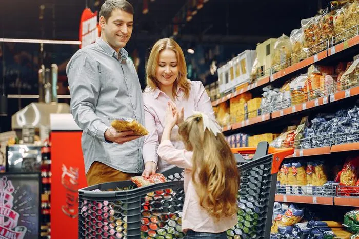 Family shopping in a supermarket aisle
